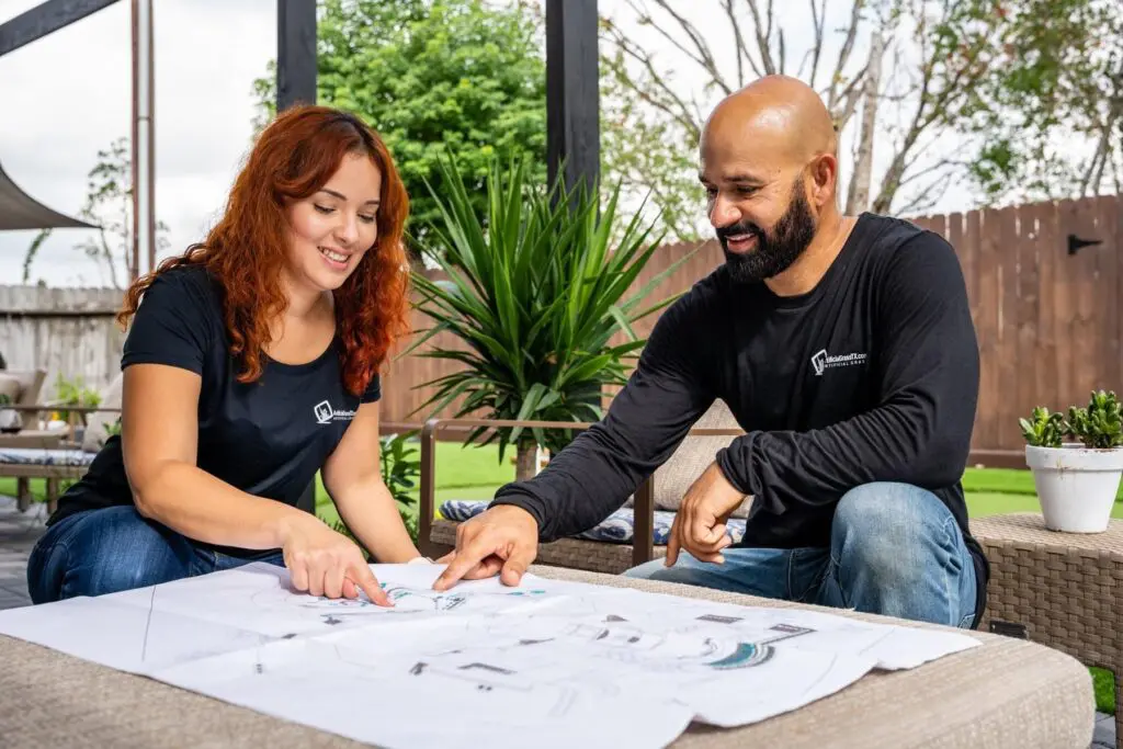 Artificial Grass TX owners Annie Mont and Jose Parodi reviewing a turf project plan