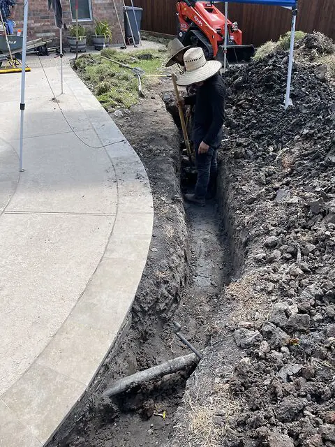 Drainage trench excavated before artificial grass installation in Houston