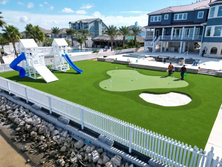 Completed Galveston artificial grass project with a custom putting green, sand bunker, poolside lawn and play area.